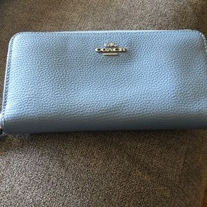 Light blue coach wallet matches the bag